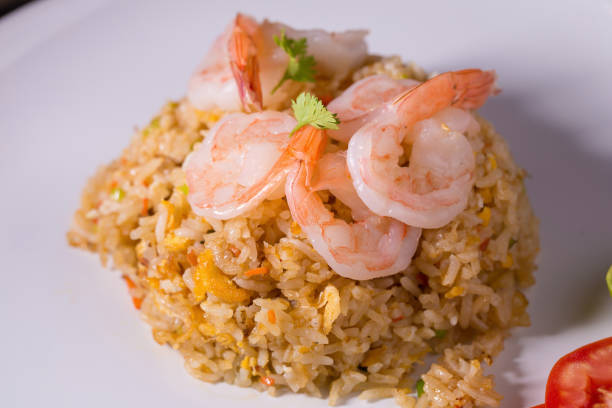 istock Thai fried rice with prawns in a white plate. 679225140