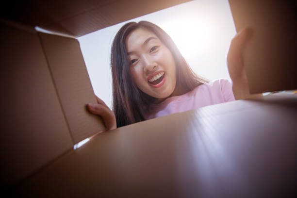 istock Young woman opening a parcel 679234774