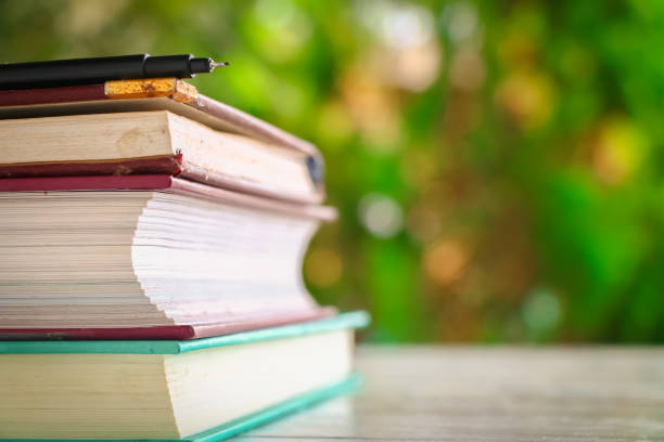 istock Group of book with pen and nature blurred background 679247294
