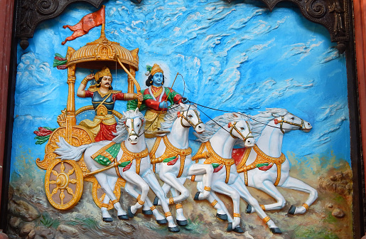 Wall art of Hindu God Krishna as charioteer and Arjuna as warrior in Mahabharata war as is in Hindu epic Mahabharat or Mahabharat in Ramkrishna math on March 19,2017 in Hyderabad,India