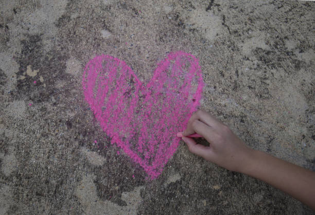 istock Hand Sketching Heart Drawing on Sidewalk 679254112