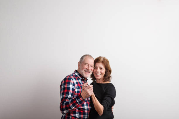 istock Beautiful senior couple in love dancing. Studio shot. 679254836