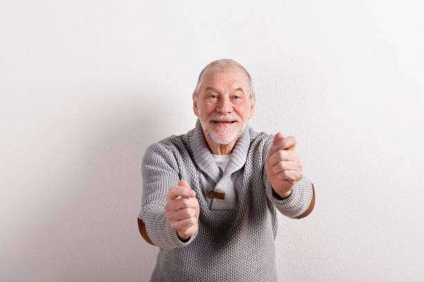 istock Senior man in gray woolen sweater, studio shot. 679255778