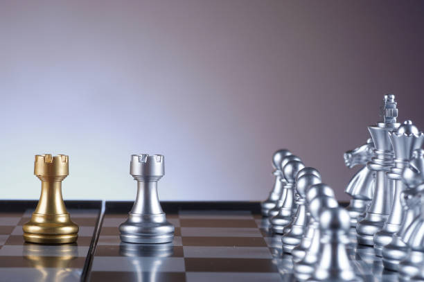 istock Silver bishop facing golden bishop set of chess on gradient background - leadership, team, successful and business concept 679262786