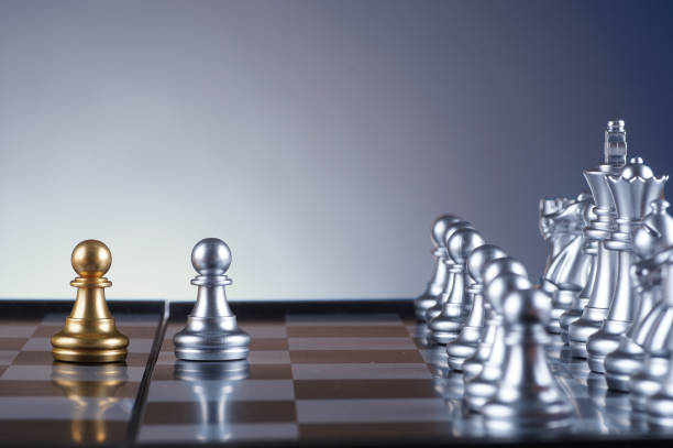 istock Silver pawn facing golden pawn set of chess on gradient background - leadership, team, successful and business concept 679270428