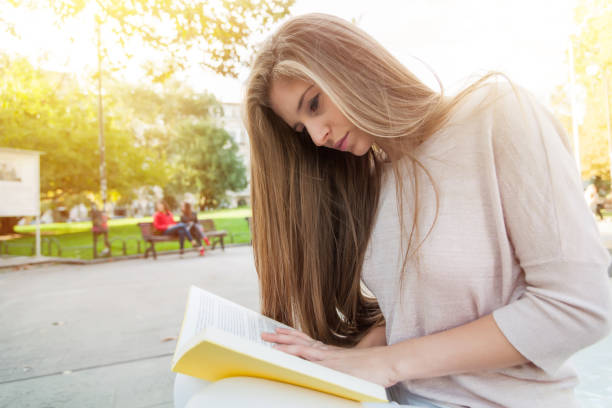 istock Teenage girl reading a book 679271492