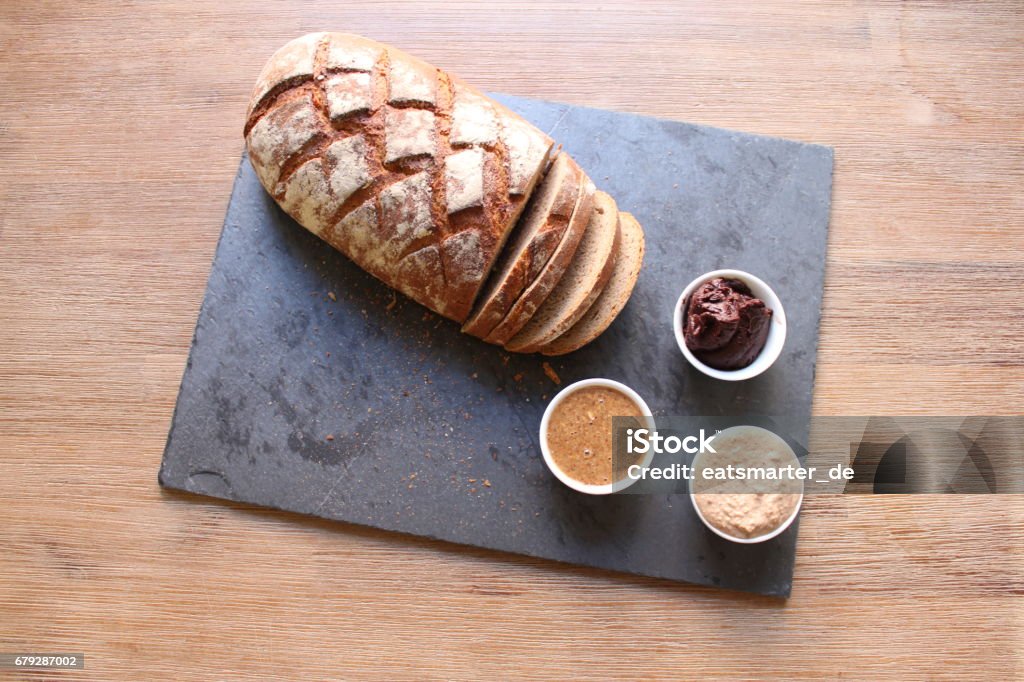 Bread with nut spread Bread with three different spreads: nut nugat, roasted almond and cashew Almond Stock Photo