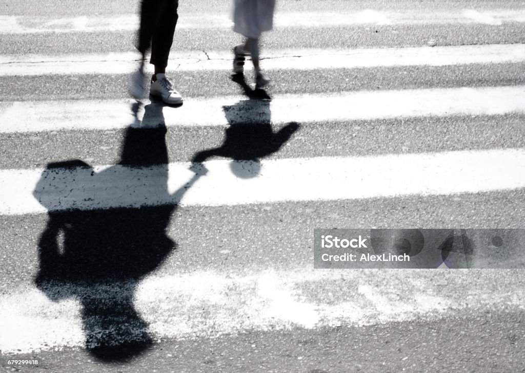 Blurry shadow of mother and child crossing the street Blurry shadow and silhouette of mother and child at zebra crossing Child Stock Photo