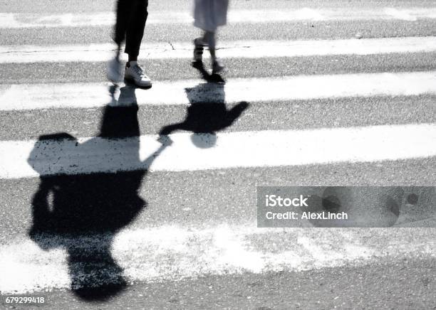 Blurry Shadow Of Mother And Child Crossing The Street Stock Photo - Download Image Now