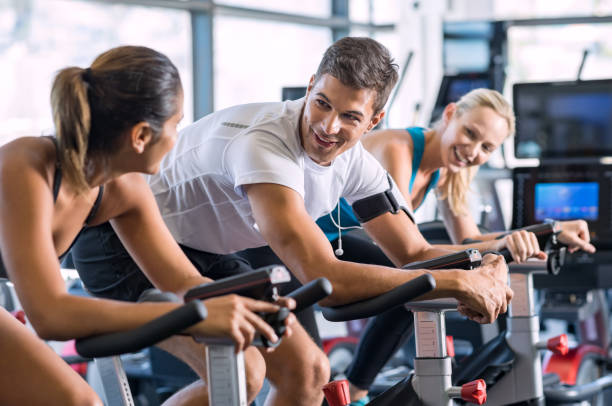 istock Fit people cycling at gym 679306666