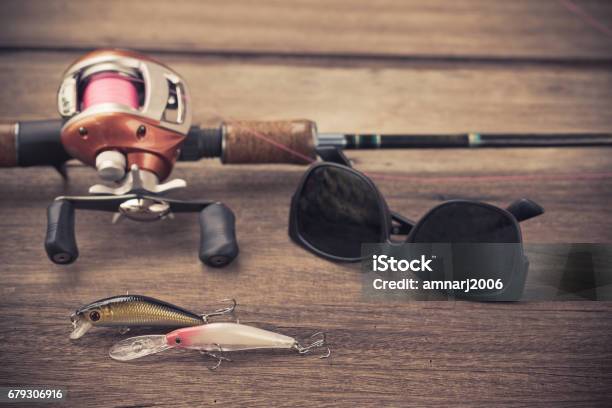 Fishing Tackle Baitcasting Reel Hooks And Lures On Wooden Background Stock  Photo - Download Image Now - iStock