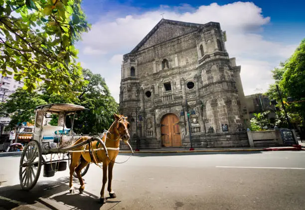 Horse Drawn Carriage parking in front of Malate church , Manila Philippines. The church is a Baroque-style church  was first built in 1588.