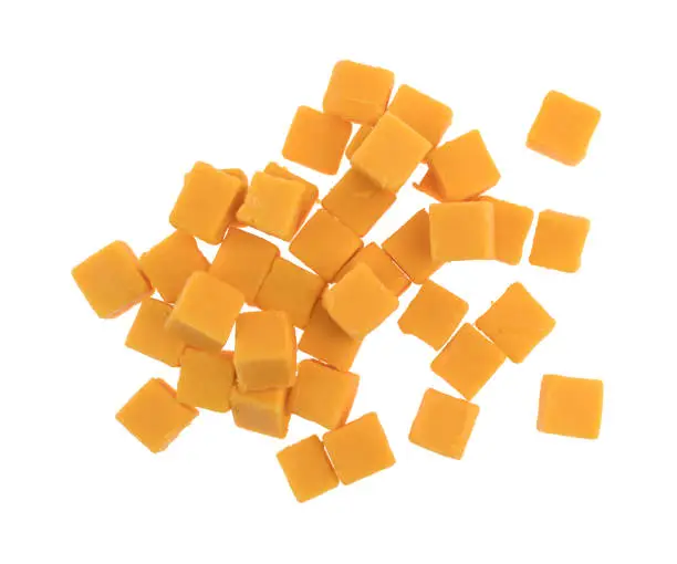 Top view of a group of cubed mild cheddar cheese pieces isolated on a white background.