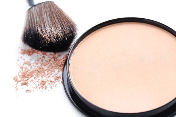 istock Makeup powder and brush on white background 679347604