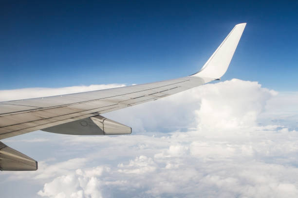istock airplane wings in the blue clouds 679352770