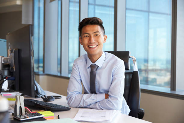 istock Portrait Of Young Businessman At Office Desk Using Computer 679352934
