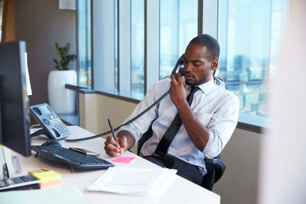 istock Businessman Making Phone Call Sitting At Desk In Office 679352942
