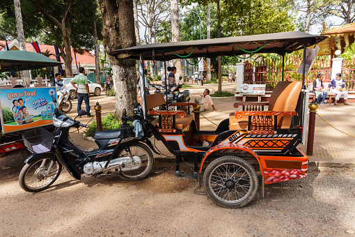 Siem Reap, Cambodia - October 29, 2016:  Modified Motorcycle  as a motorized tricycle  for carrying passengers parking in the park near Preah Ang Chek and Ang Chom Shrine, at Siem Reap, Cambodia,