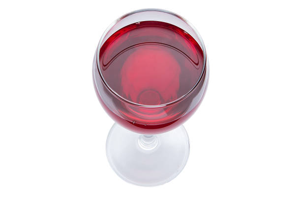 A glass of red wine is a top view. Alcoholic drink on a white background. stock photo