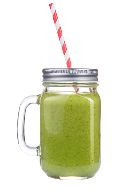 istock Healthy refreshing fruit smoothie with straw in a jar mug isolated on white. 679360830