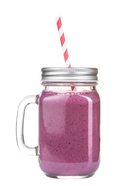istock Healthy refreshing fruit smoothie with straw in a jar mug isolated on white. 679360902