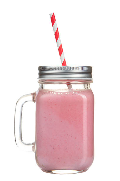 istock Healthy refreshing fruit smoothie with straw in a jar mug isolated on white. 679361384