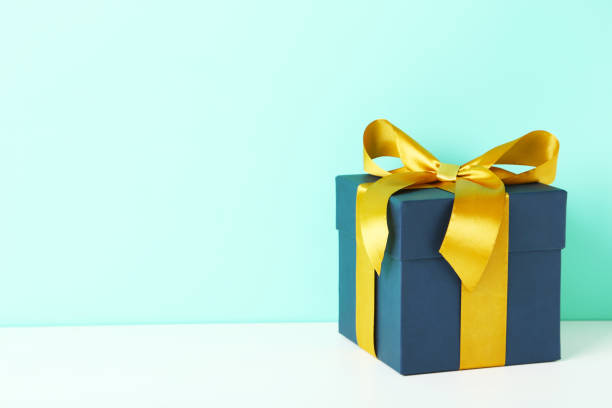 istock Gift box with ribbon on white wooden table 679418570