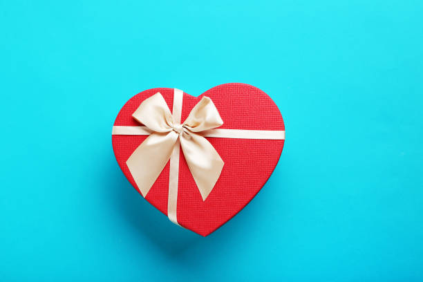 istock Heart gift box with ribbon on blue background 679421814