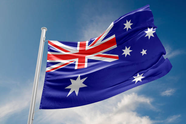 istock Australian Flag is Waving Against Blue Sky 679437940