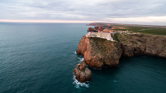 View of the lighthouse and cliffs at Cape St. Vincent at sunset. Continental Europe's most South-western point, Sagres, Algarve, Portugal.