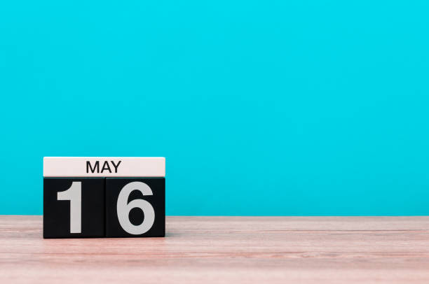 istock May 16th. Day 16 of month, calendar on turquoise background. Spring time, empty space for text. Biographers Day 679454098