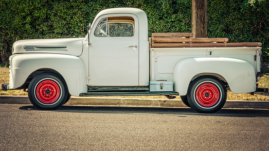 A white pickup sitting on a southern California street.