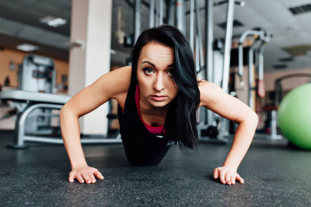 istock A woman trains in the gym performs plank exercise 679462556