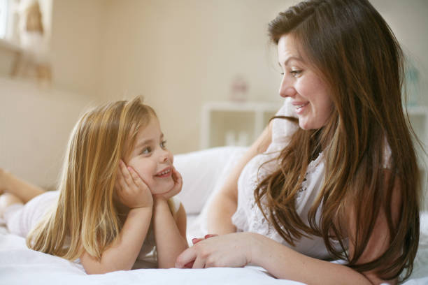 istock Mother with her cute little daughter on bed. 679463312