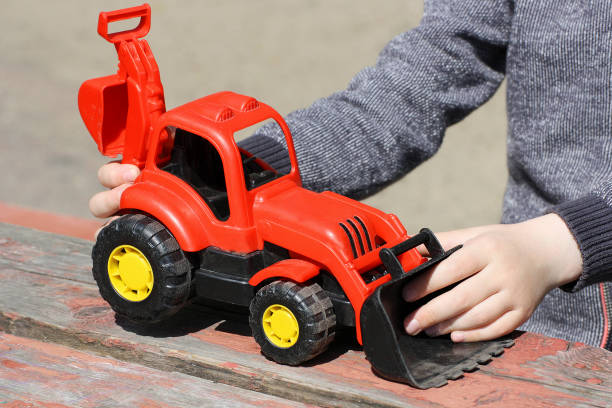 istock A child plays with a red toy construction vehicles. 679483840