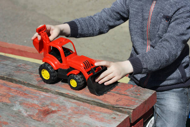 istock A child plays with a red toy construction vehicles. 679483860