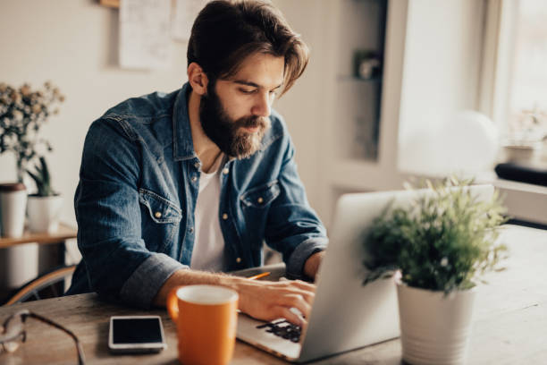 istock Young blogger writing an article on laptop 679484024