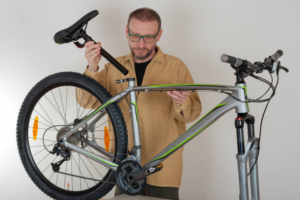 istock Bearded caucasian man putting a saddle on the mtb bicycle 679485154