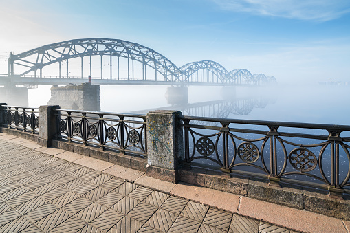 Railway bridge over Daugava river in Riga at sunrise