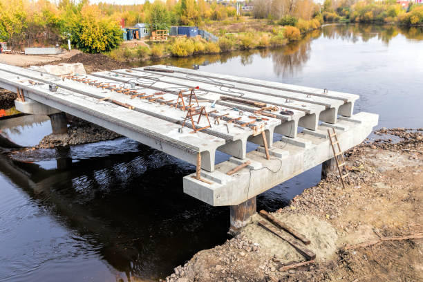 Concrete bridge across Tagil river under-construction of its foundation and road surface supporting structure.