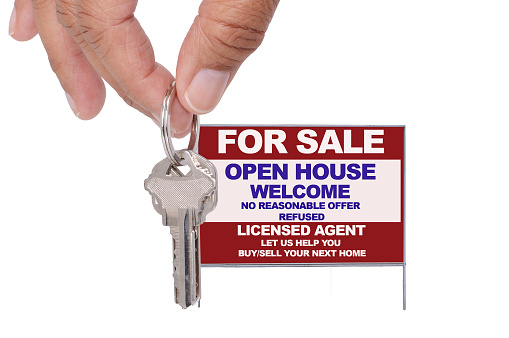 Hand keys for sale open house welcome real estate sign isolated on white background