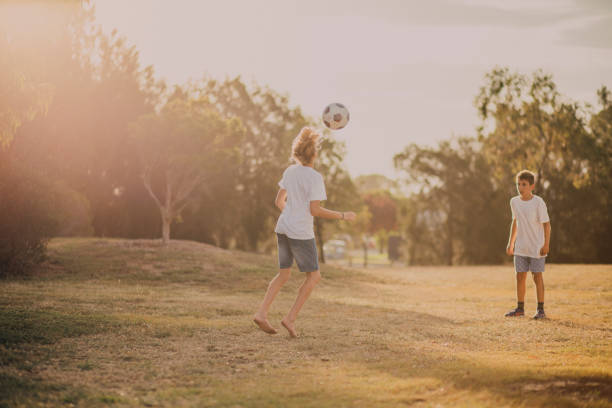 istock Young Boys Playing Soccer in the Park 679510896