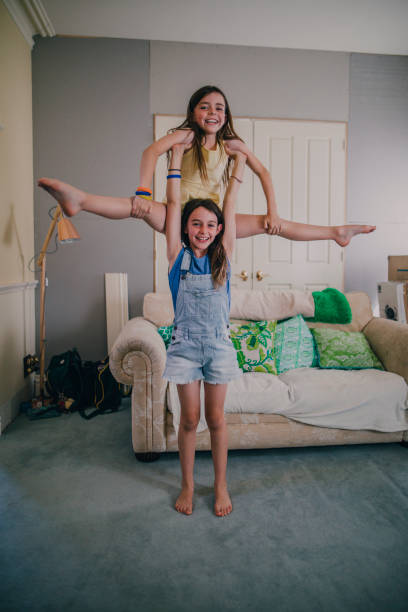 istock Little Girls Doing Gymnastics at Home 679511024