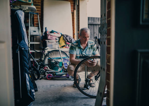 Inflating Tire of Bicycle in His Garage