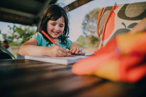 Little Girl Drawing in a Colouring Book