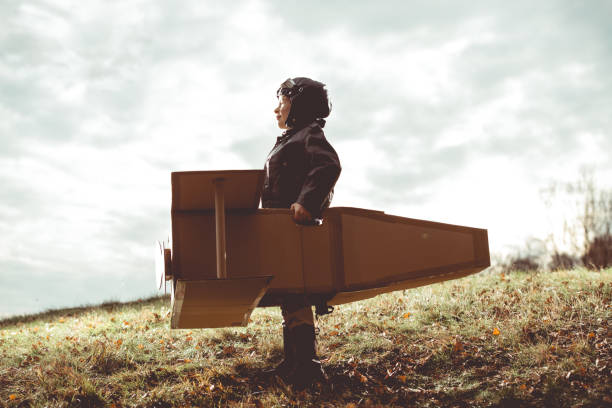 istock front view vintage pilot boy flight by imagination on cardboard plane outdoor 679513286