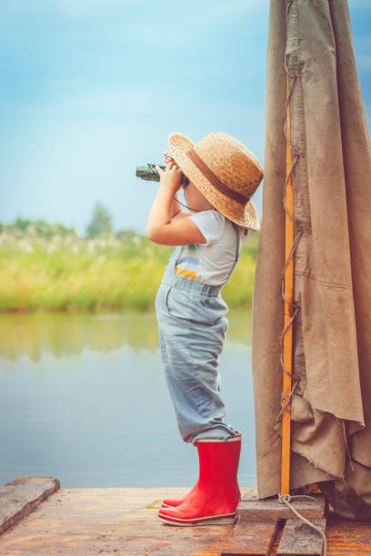 child traveling on raft - wood tranquil scene serene people lake imagens e fotografias de stock