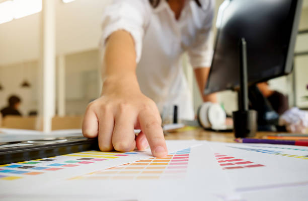 istock Graphic design and color swatches and pens on a desk. Architectural drawing with work tools and accessories. 679528626