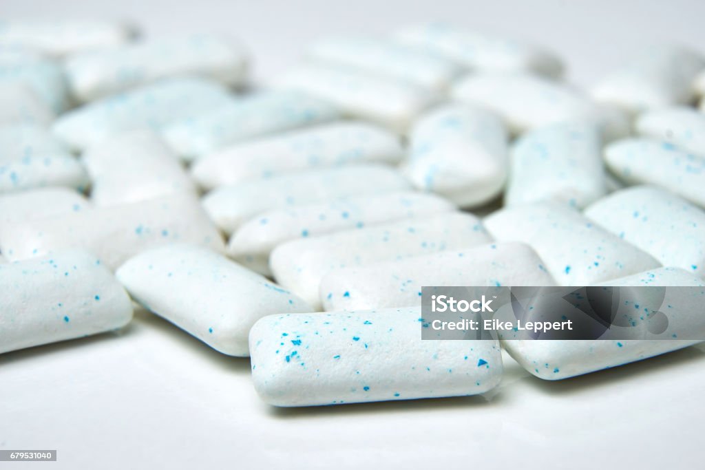 Chewing gum spilled out on white background with low depth of field - macro shot. Chewing gum spilled out on white background with low depth of field - macro shot Bubble Gum Stock Photo