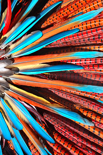 Multi-colored feathers in native american indian chief headdress. Close-up photo